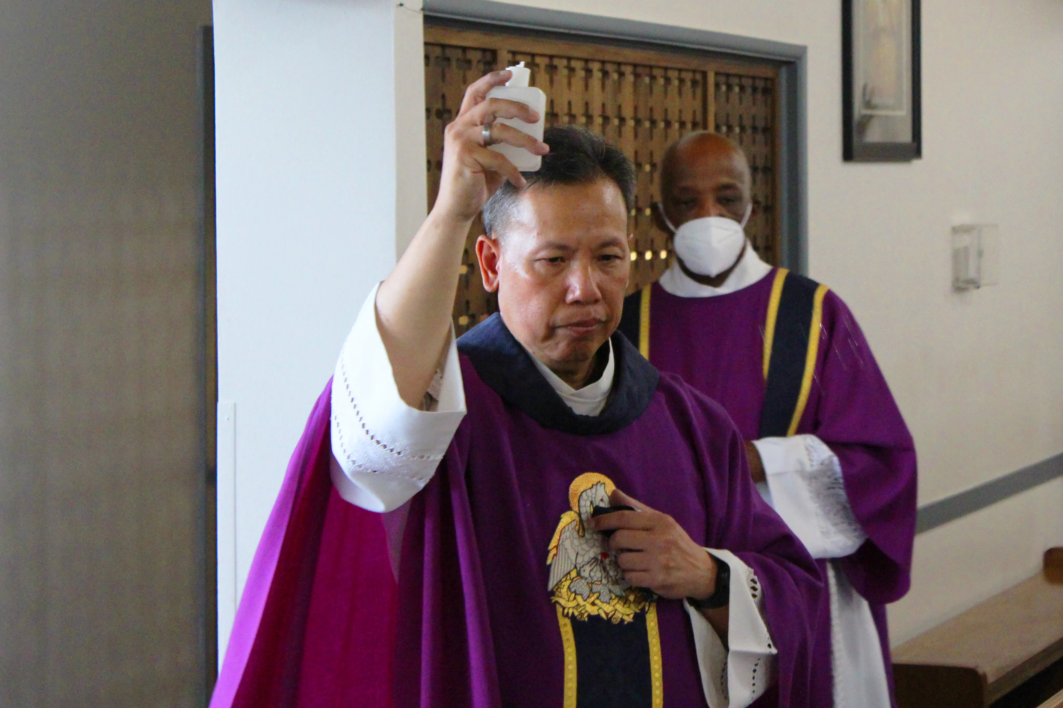 Father Joseph Cao, assisted by Deacon Clarence McDavid, blesses the parts of the church affected by an Aug. 30 break-in, during a Mass of reparation at Curé d'Ars Catholic Church in Denver, Colo., Sept. 1, 2021.?w=200&h=150